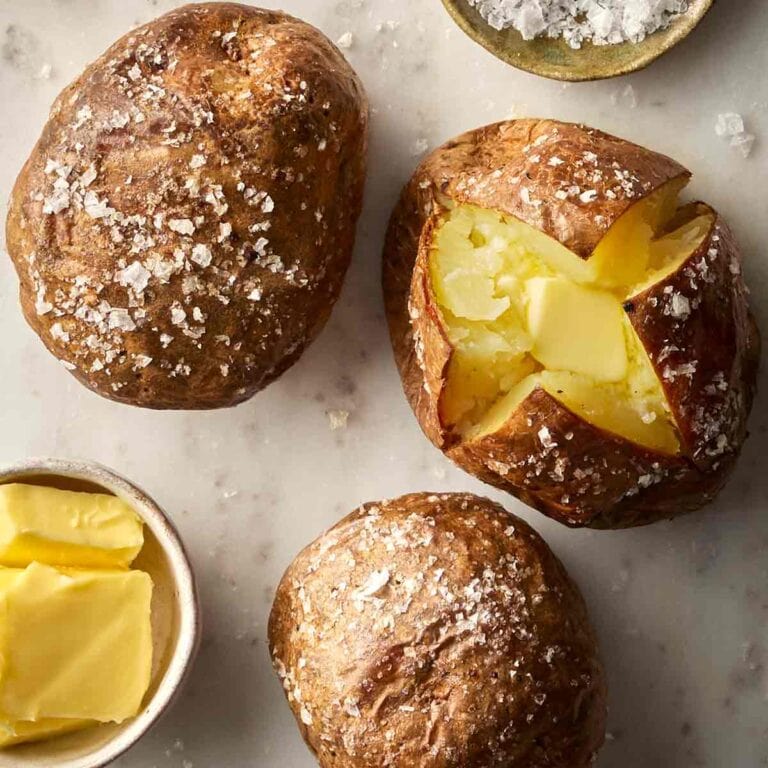 Jacket potatoes on a surface, ready to eat.