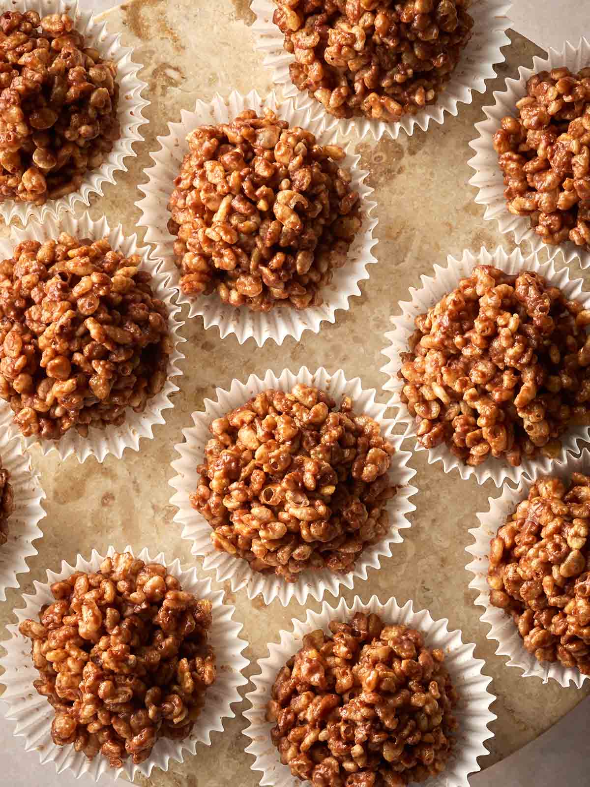 A view from above of a batch of rice crispy cakes in cupcake cases.
