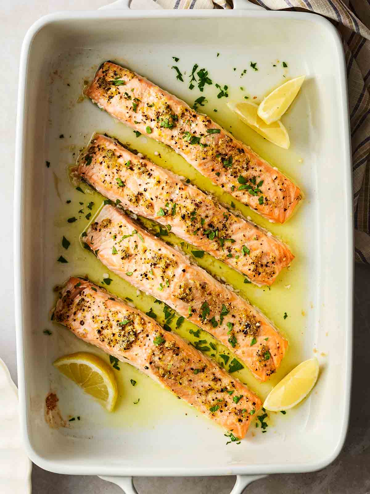 An oven dish with baked salmon, ready to eat.