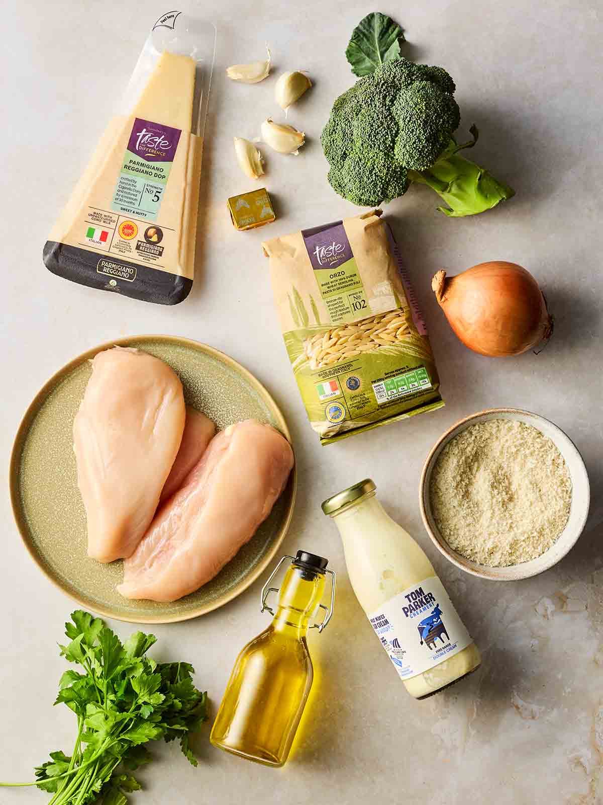 Chicken Kiev Pasta ingredients laid out on a white surface.