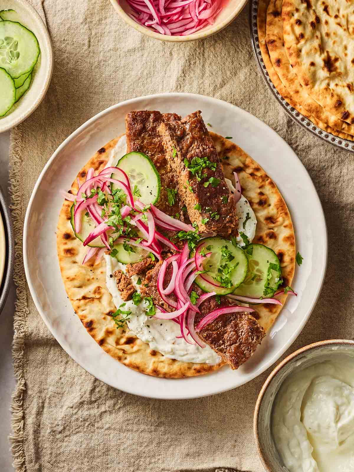 A homemade kebab with salad and sheet pan beef mince inside, on a table, set and ready to eat.