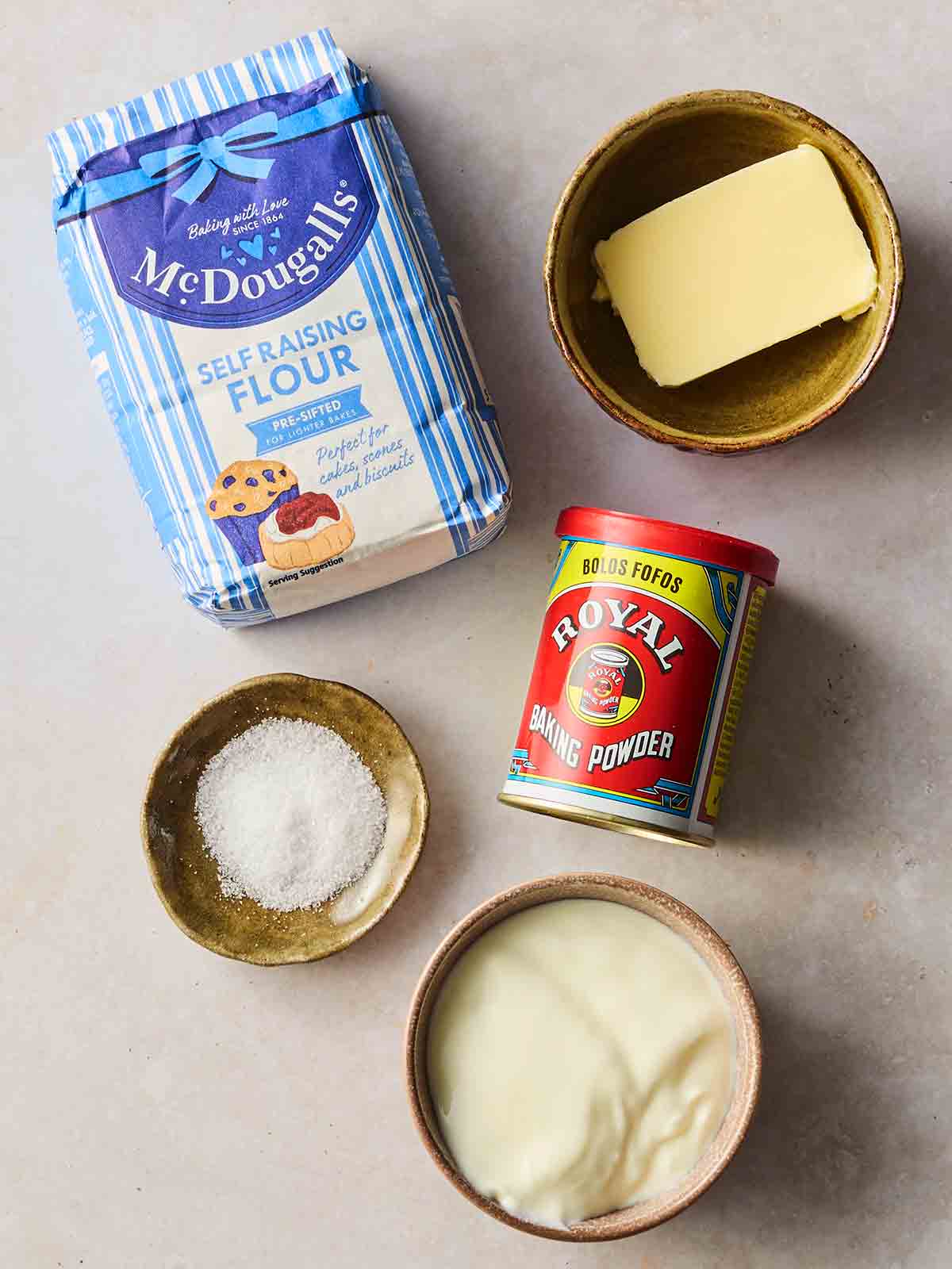 Ingredients for making homemade flatbreads laid out on a white surface.