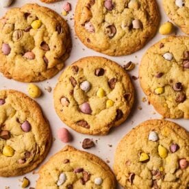 Cookies with mini eggs on a white surface, baked and ready to eat.