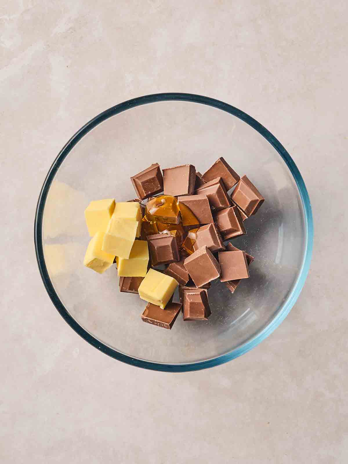 Chocolate, butter and golden syrup in a bowl.