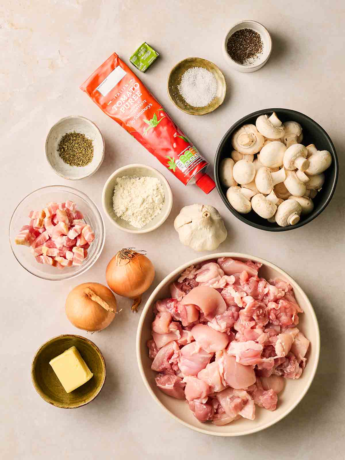 The ingredients for making Chicken Chasseur on a white counter.