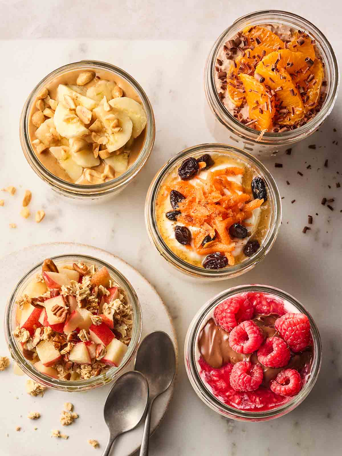 A bird's eye view of different toppings on top of overnight oats.