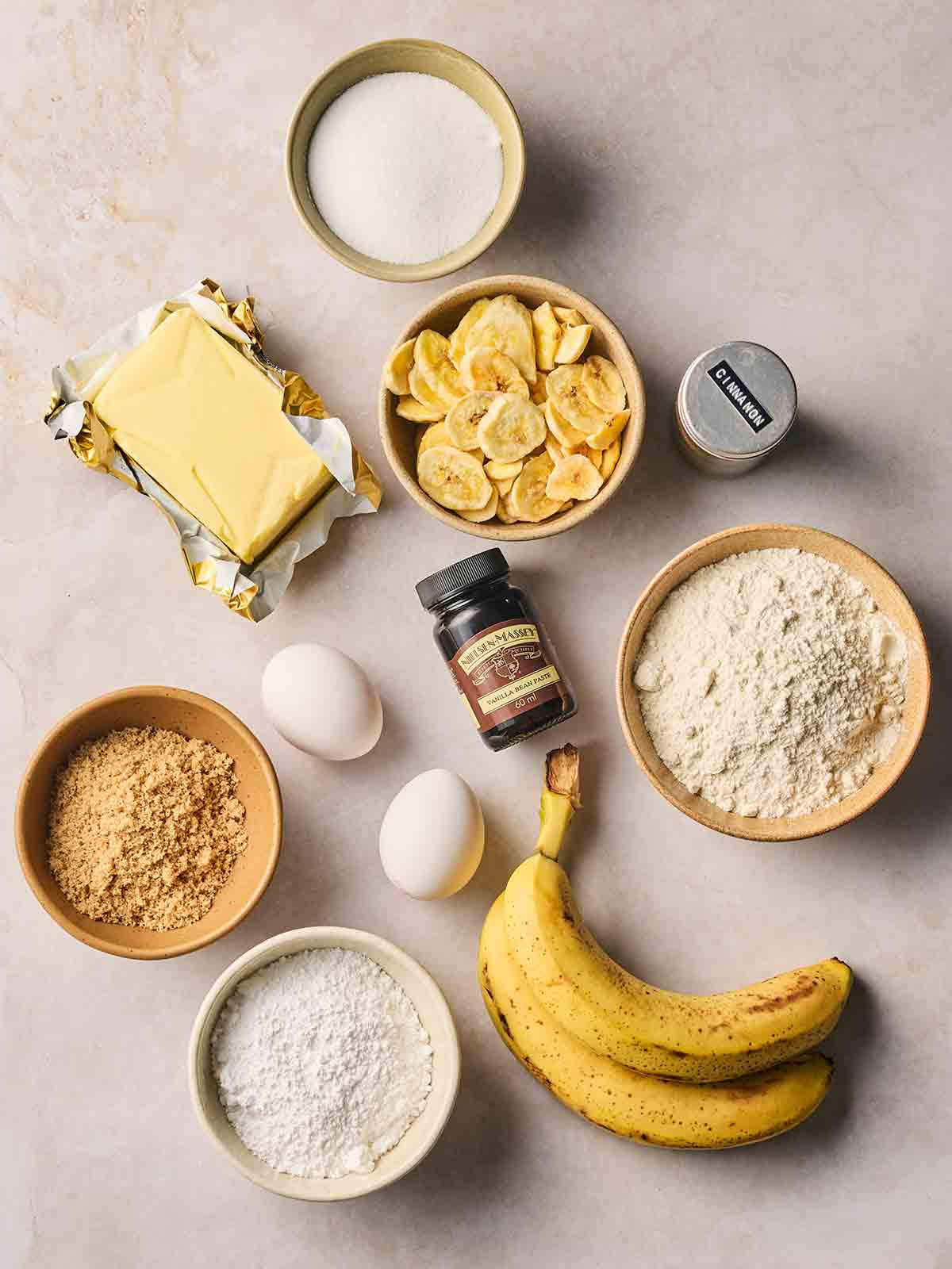 The ingredients for making Banana Cupcakes laid out on a counter top.