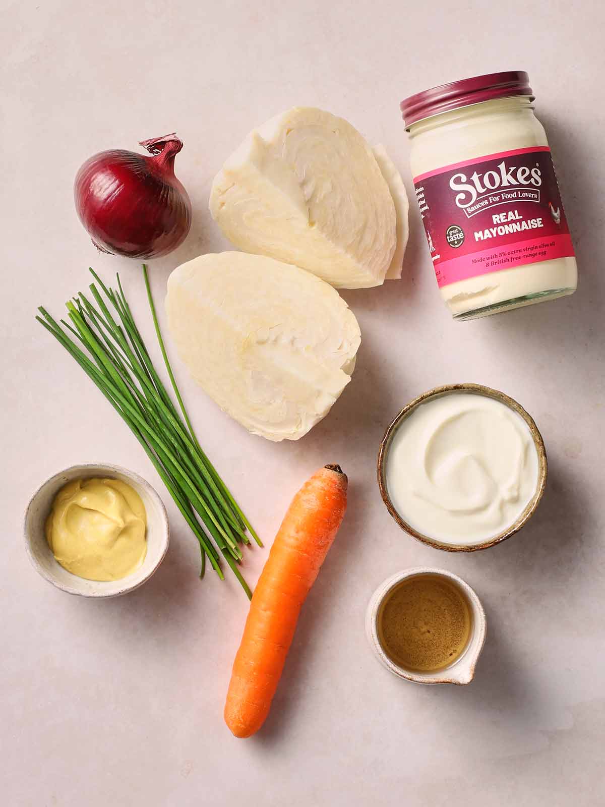 The ingredients for homemade coleslaw laid out on a counter top.