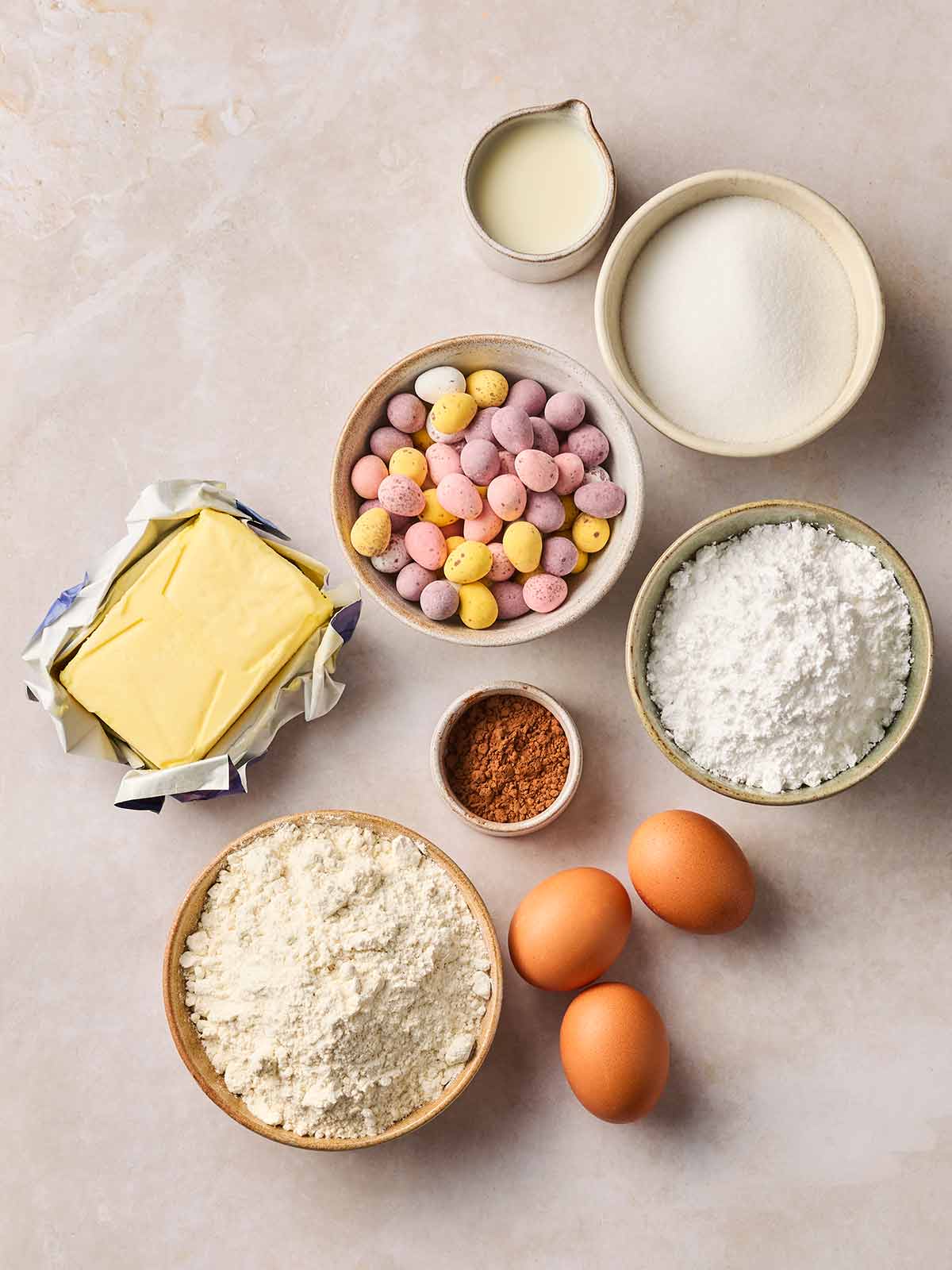 The ingredients for making Easter Cupcakes laid out on a white counter.
