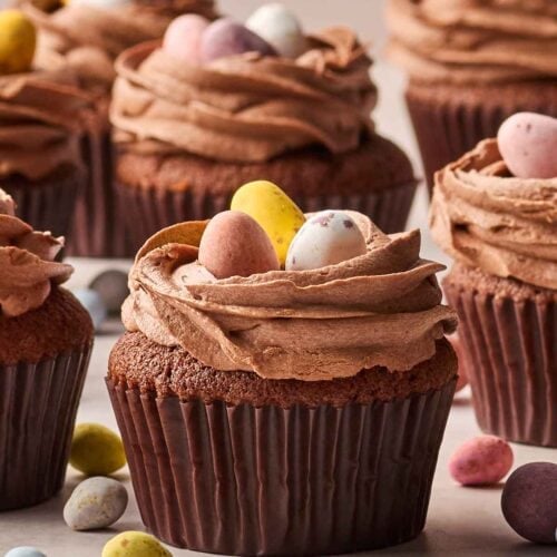 A batch of Easter Cupcakes with mini eggs on top.
