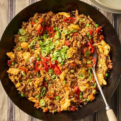 A wok of Egg Fried Rice on a table, ready to serve.