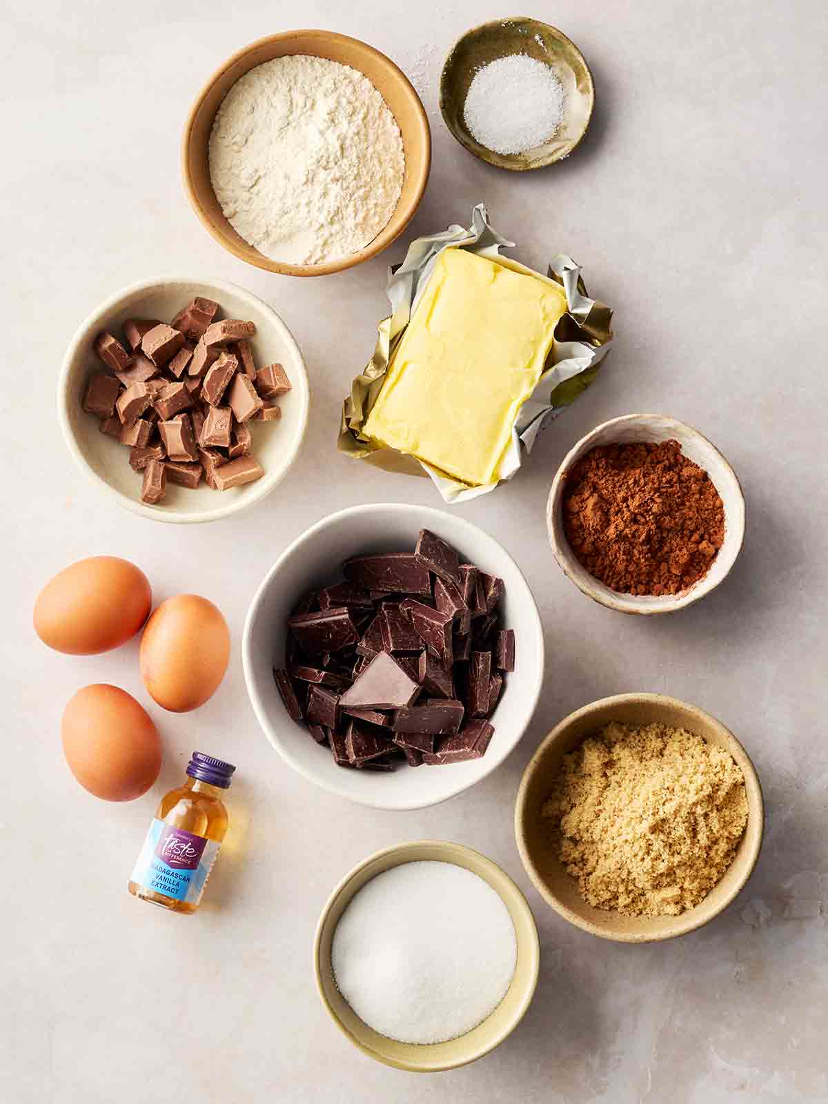 The ingredients for making Fudgy Brownies laid out on a white counter top.