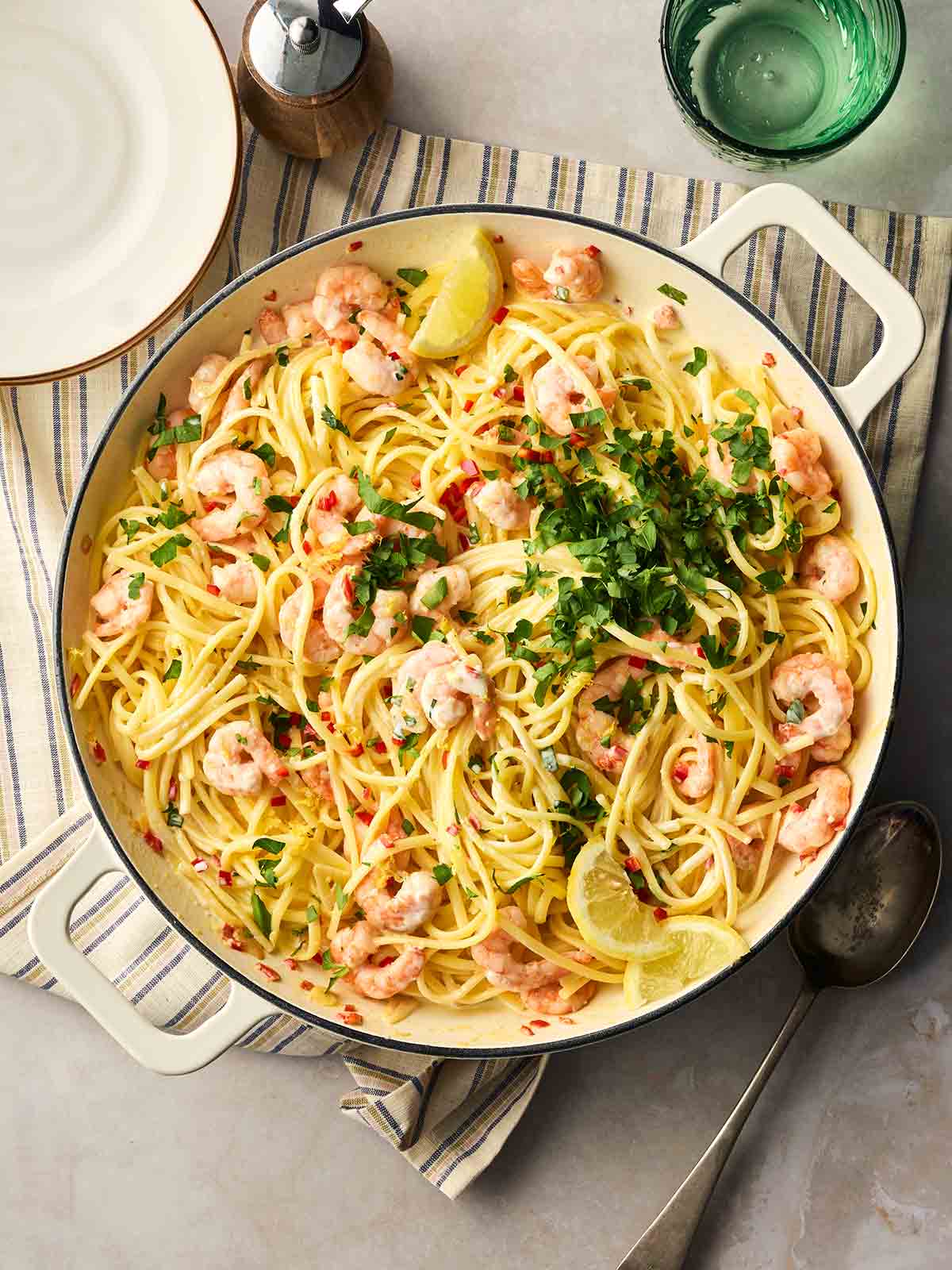 A large pan of prawn linguine on a table, ready to be served up.