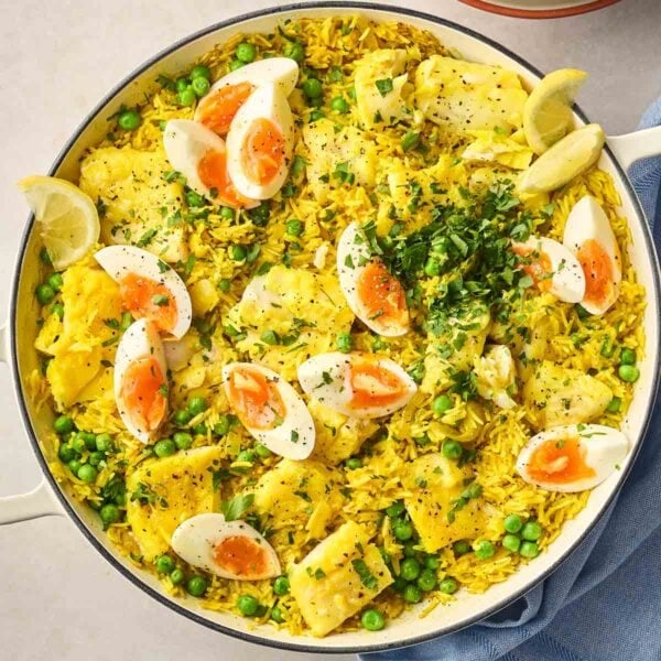 A close up of a pan of Kedgeree, with a bright colour, rice, fish and eggs.