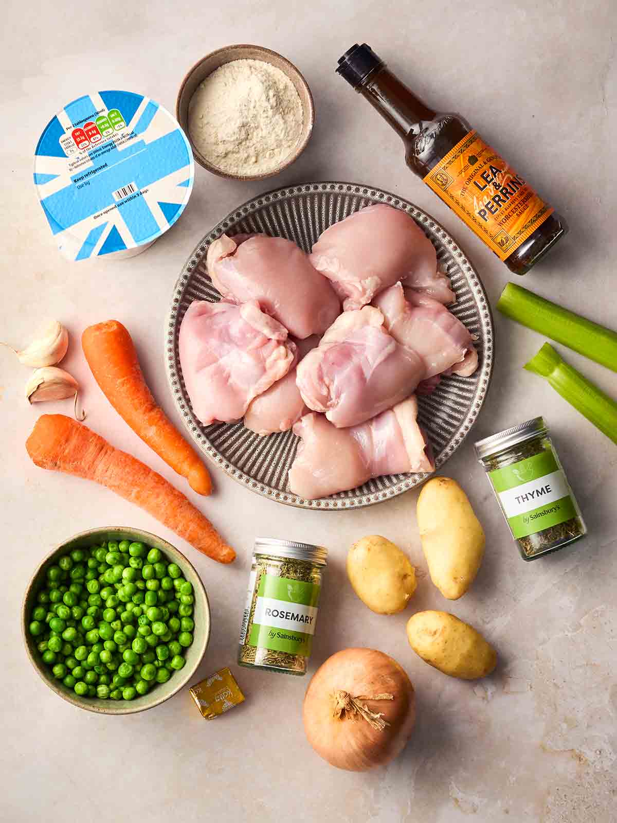 The ingredients for making Chicken Stew laid out on a white surface.